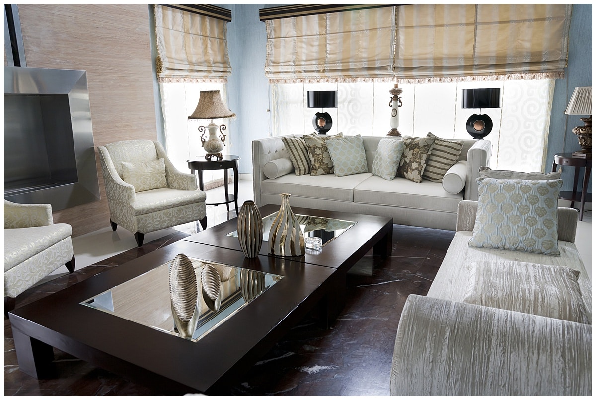 Living room with white couches and long coffee table