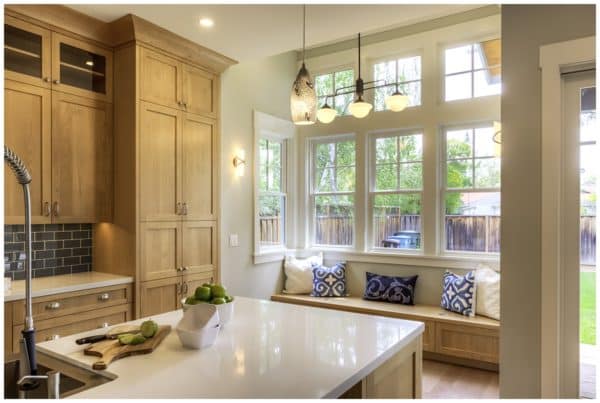 Dining area with built-in seating in front of large windows